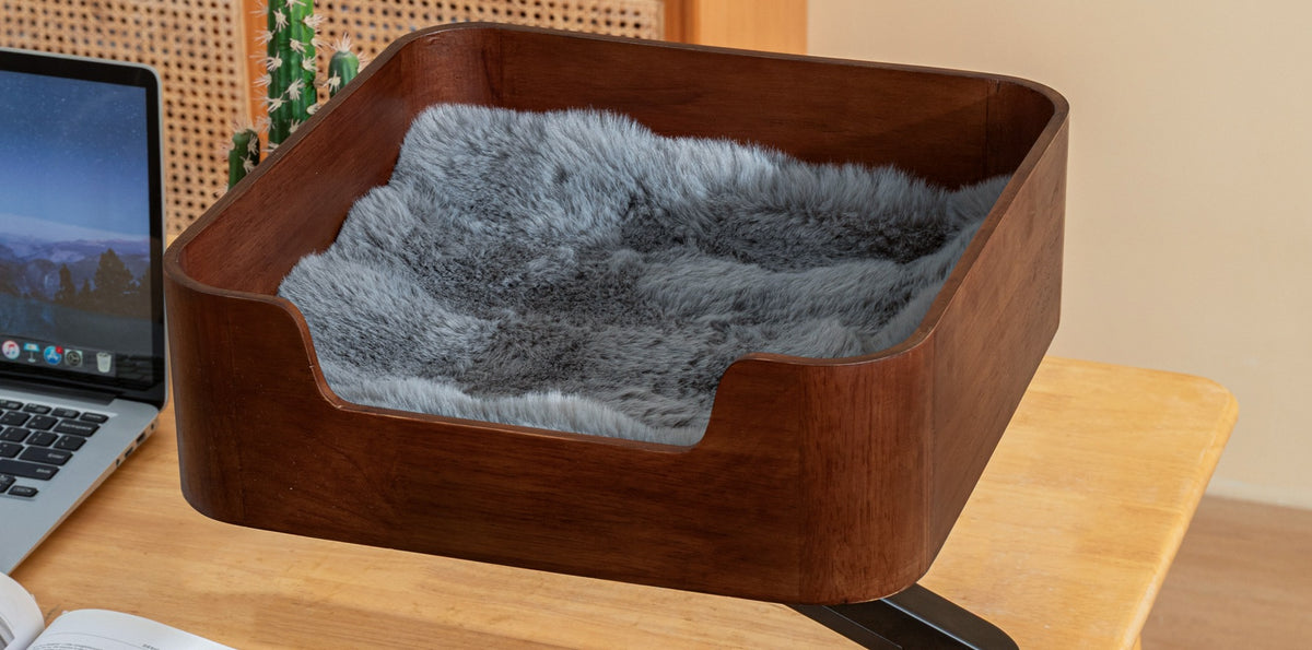 Walnut Catomi desk cat bed with grey cushion on a desk