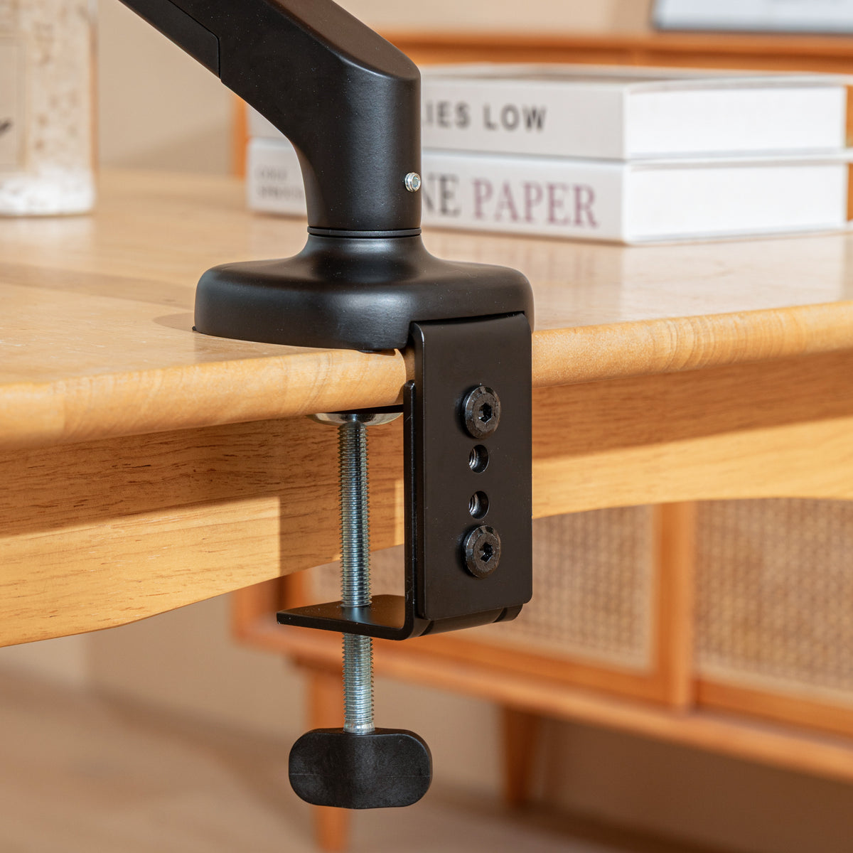 Clamp with screw knob holding the Catomi desk cat bed arm to the edge of a wooden desk