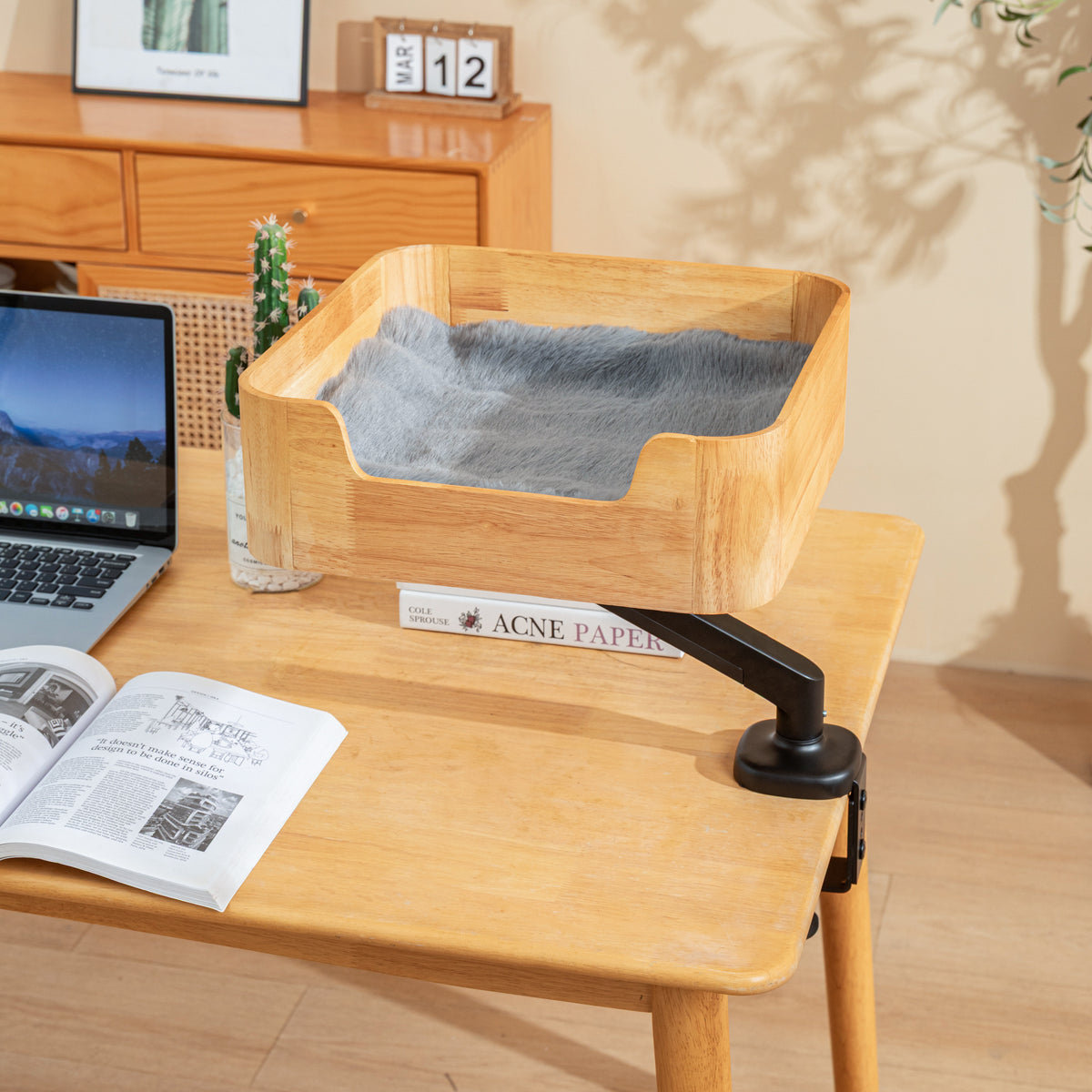 Catomi wooden desk cat bed in Natural with a soft grey cushion, mounted over a home office desk