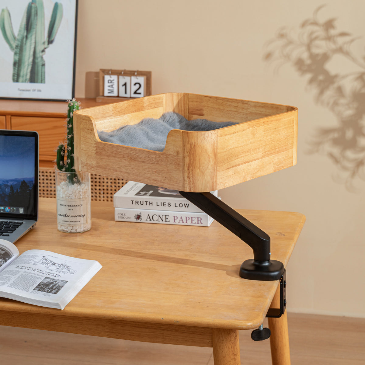 Catomi desk cat bed in Natural with a faux fur cushion, clamped to the edge of a work desk